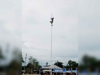 Aksi Reza Mangar memanjat tiang bendera